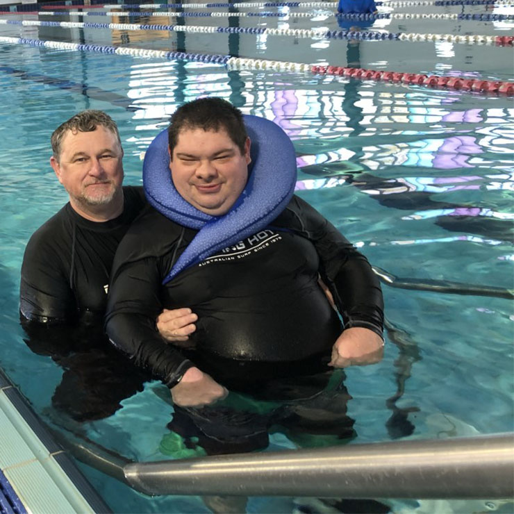 Carer at Waminda helping participant swim